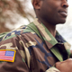 Close Up Of American Flag On Uniform Of Soldier Carrying Kitbag Returning Home On Leave - PhotoDune Item for Sale