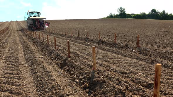 TIMELAPSE VINE PLANTING SITE WITH LASER GUIDED TRACTOR