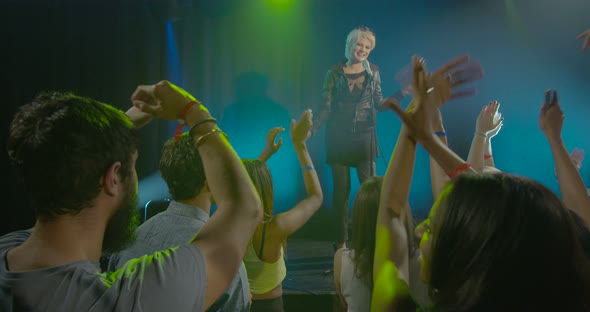 Young woman singing in front of audience