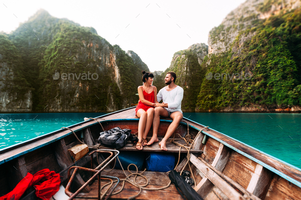 A couple in love travels by boat to the Islands. Honeymoon trip. Honeymoon on the Islands