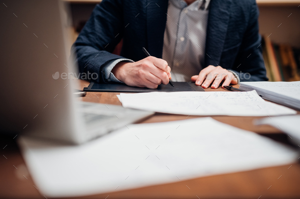 Close up man using digital tablet - freelance creative businessman holding touch pen sketching