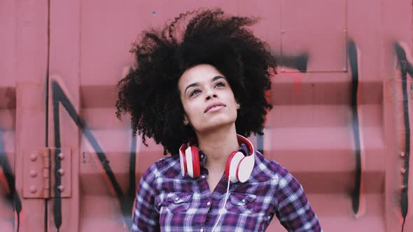 Portrait of pretty Afro American Female on street looking to camera