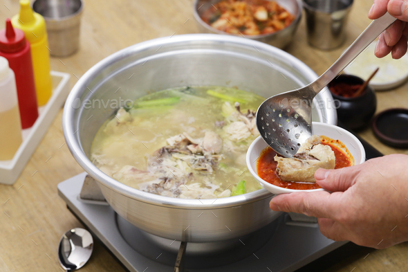 korean whole chicken soup hot pot, chicken is eaten with tadegi (spicy condiment). - Stock Photo - Images