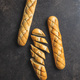 Roasted baguette with garlic butter. Crunchy sliced garlic bread on black table. - PhotoDune Item for Sale
