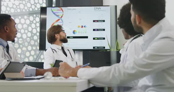 Multiracial Medical Colleagues which Analyzing Dna Structure During Symposium in Boardroom alt