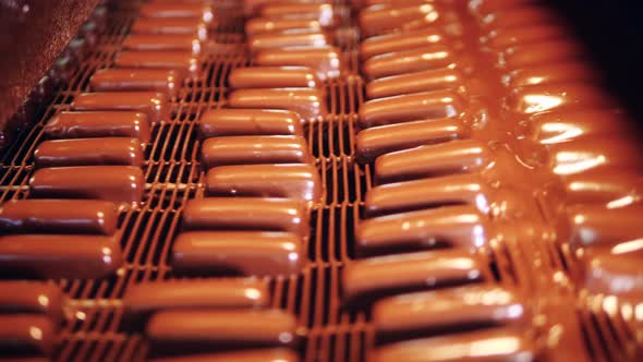 Sweets are Getting Glazed in Chocolate While Getting Transported alt