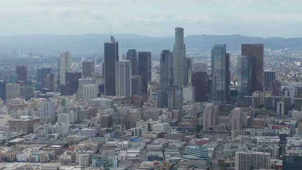 AERIAL: Slowly Circling Downtown Los Angeles Skyline with Warehouse Art District in Foreground with alt