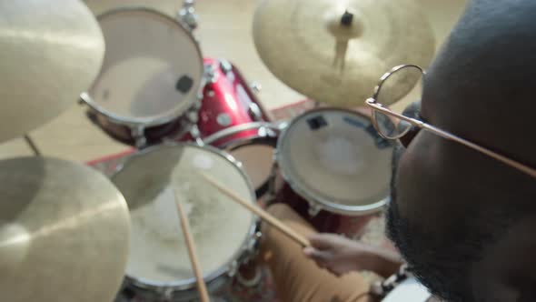 African American Drummer Playing Drumkit alt