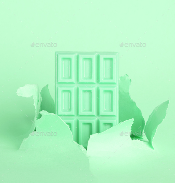 Chocolate mint green tiles on pastel background against the background of hole burst paper. The