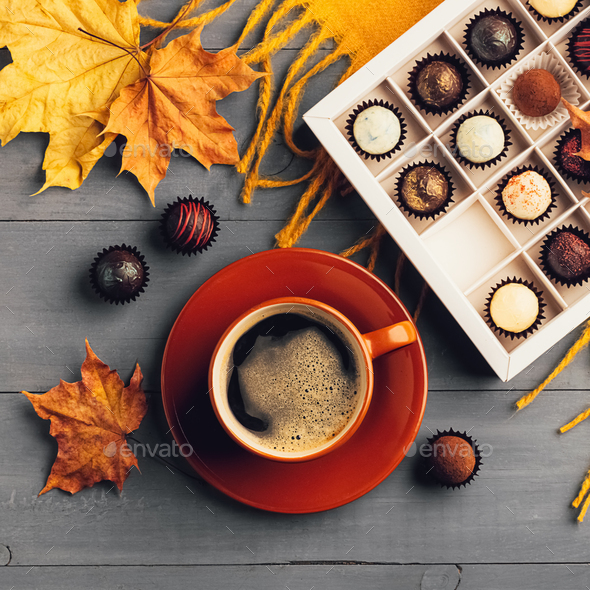 Cup of black coffee box of chocolates on an autumn background. Selective focus. Copy space. Top view