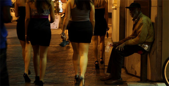 Homeless Man And Club Girls On City Street