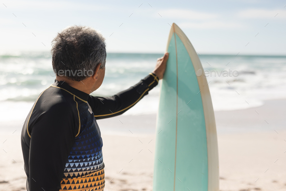Surfing, surfboard and senior man on beach for water sports while