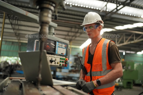 industrial factory employee working in metal manufacturing industry - Stock Photo - Images