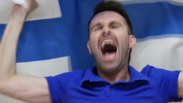 Finnish Fan Celebrates Holding the Flag of Finland alt