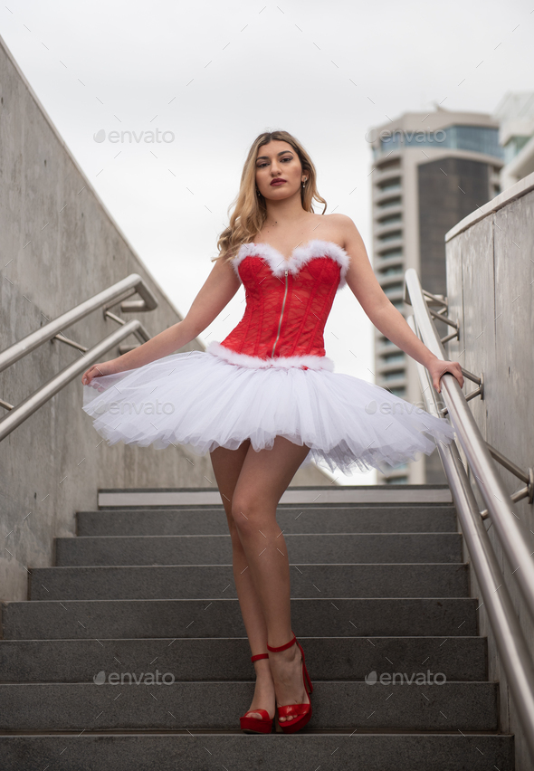 Ballerina wearing high heels and christmas dress posing outdoors