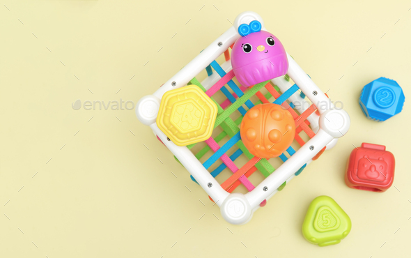 top view of kids educational toy, colorful cube with details for skills developing and brain boost