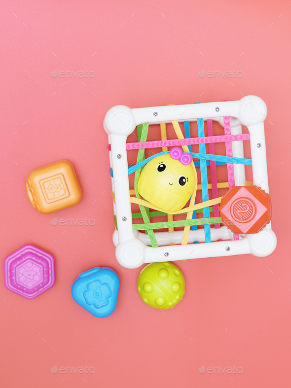 top view of kids educational toy, colorful cube with details for skills developing
