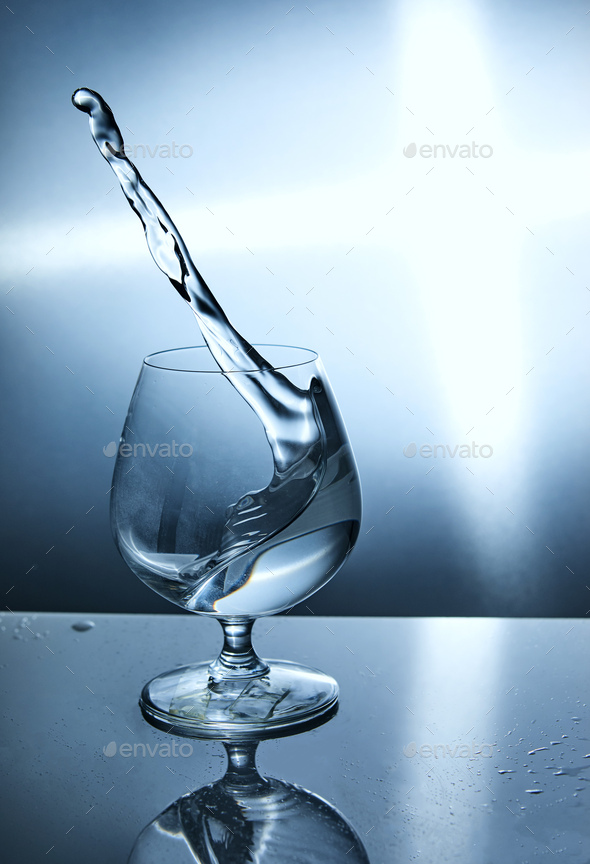 Glass of water with a wave on a blue background