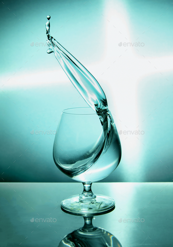 Glass of water with a wave on a blue background