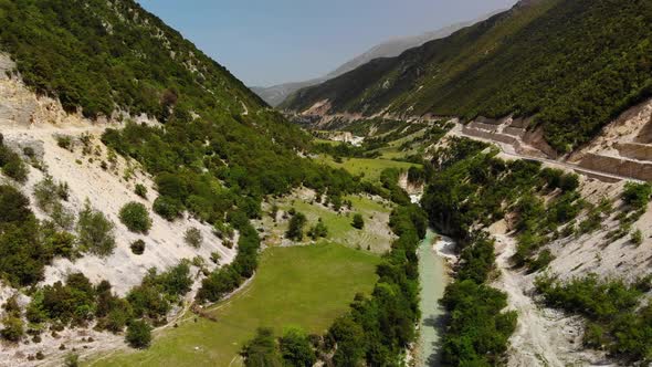 Aerial Drone Footage View Flight Over Mountain with Forests Fields and River
