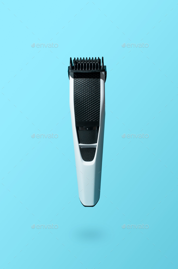 Beard trimmer on a blue background. Levitating new electric beard and mustache clipper.