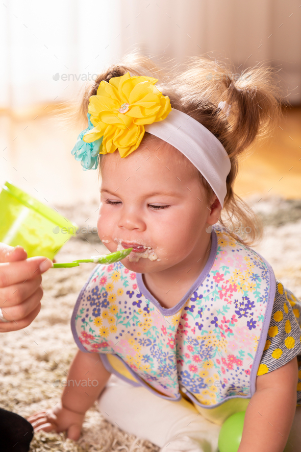 Baby girl eating vegetable pap