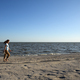 Woman walking along deserted sea beach in evening - PhotoDune Item for Sale