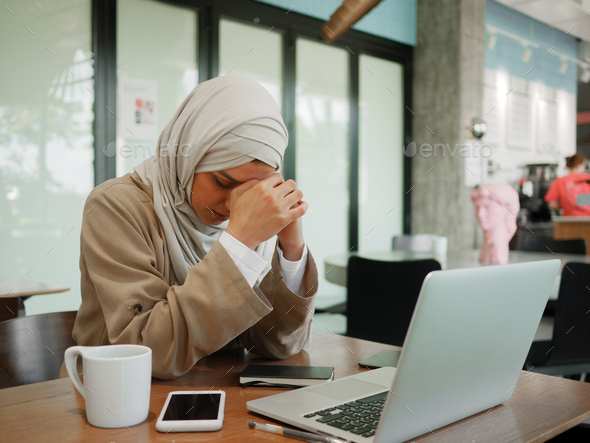 Muslim woman on remote working, online education or video conversation in caffe - Stock Photo - Images