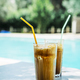 Two glass of iced frappe near the swimming pool. - PhotoDune Item for Sale