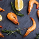 Top view of shrimps with lemon and rosemary on black background. - PhotoDune Item for Sale