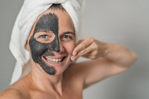 Happy mature woman having skin care spa day - People wellness lifestyle concept