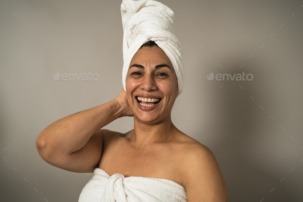 Happy Latin mature woman having skin care spa day - People wellness lifestyle concept