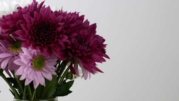 Spring bouquet of beautiful flowers in different colors rotates 360 on a gray background. alt