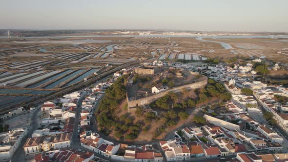 Castro Marim castle and geometrical field shapes created by salt pans. Algarve, Portugal alt