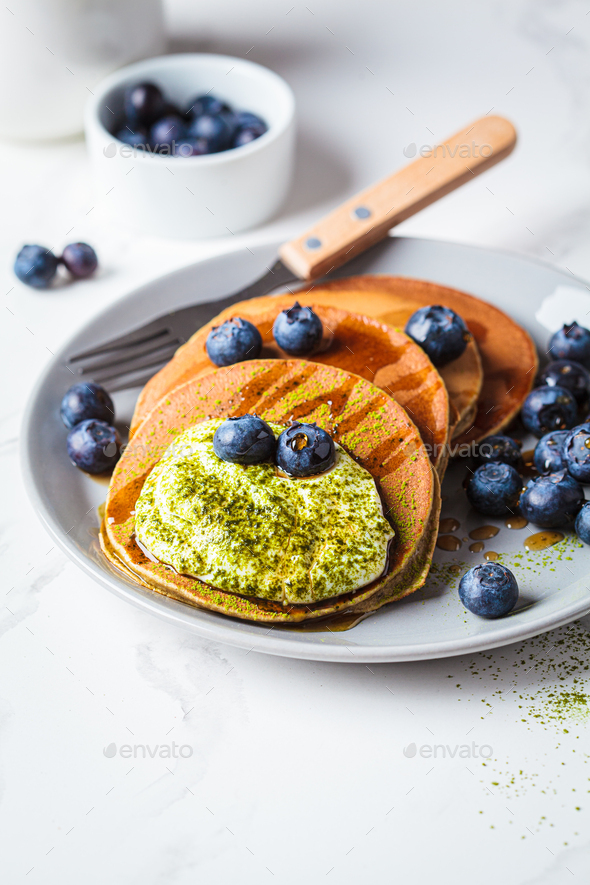 Matcha pancakes with coconut cream, blueberries