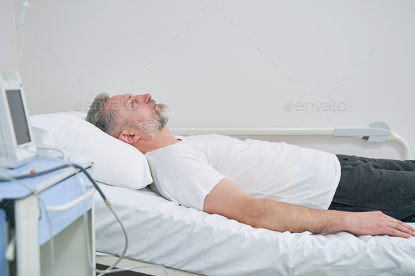 Tranquil mature male patient staying in hospital