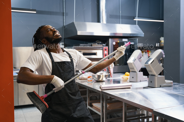 Funny chef cleaning floor at the kitchen Stock Photo by svitlanah |  PhotoDune
