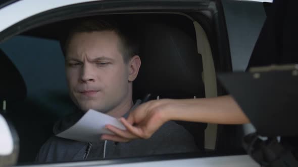 Woman Cop Giving Parking Ticket to Man in Car, Law Violation, Traffic Offence alt