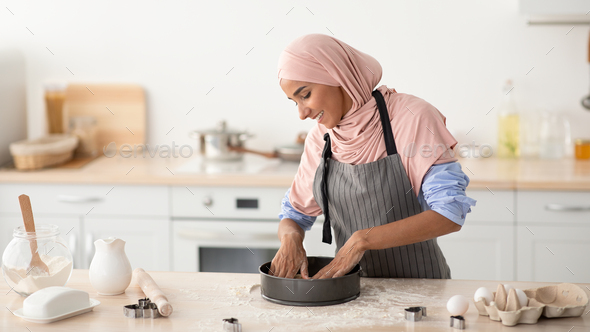 Happy Housewife. Young Islamic Lady In Hijab And Apron Baking At Home - Stock Photo - Images