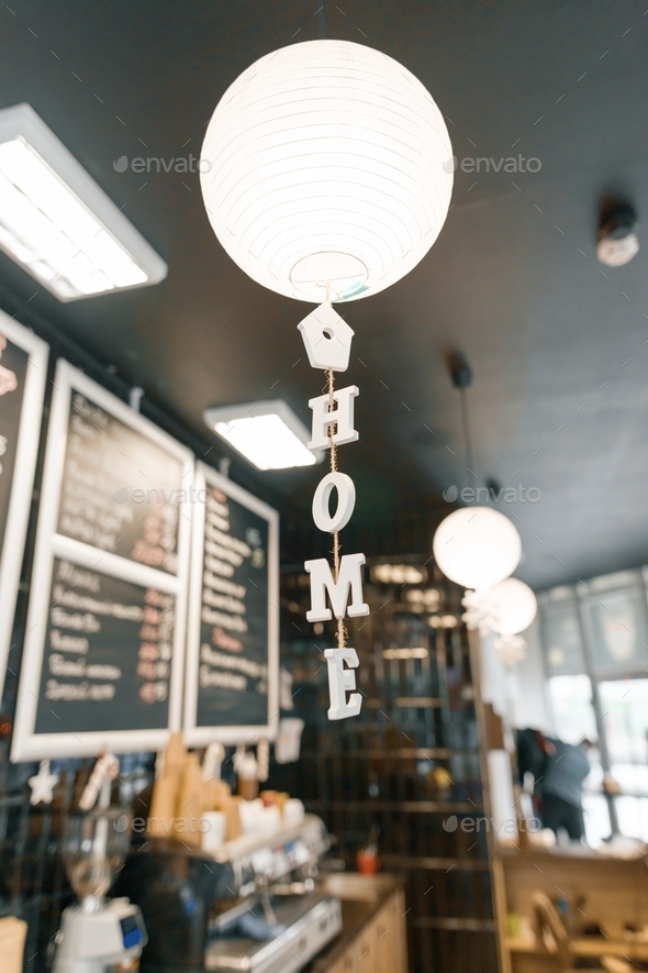Modern coffee shop, interior, bar counter, focus on white round paper lamp