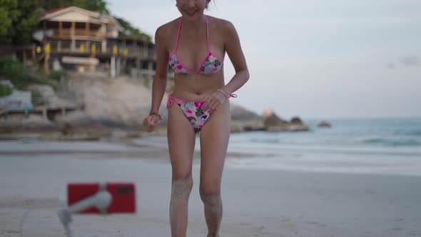 Asian Girl Video Blogger Recording TikTok Video on Island Beach at Sunset alt
