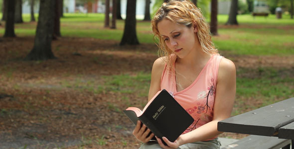Woman Reads Bible Outside