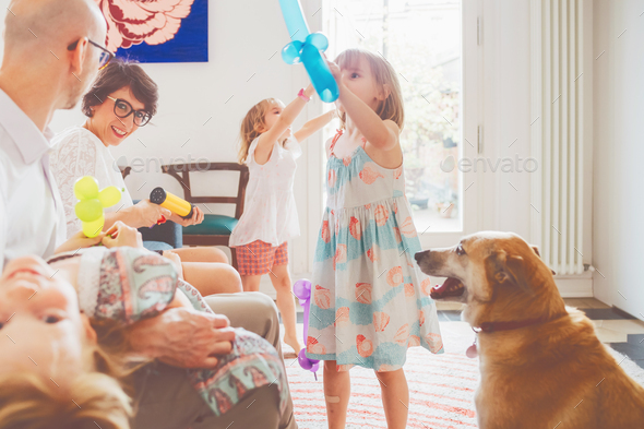 family indoor playing with balloon toys