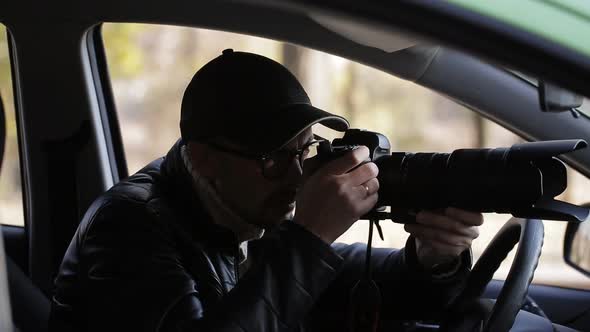 Spy Paparazzi or Detective in the Car Shooting on Camera
