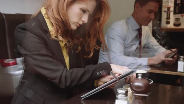 Businesswoman using digital tablet in cafe