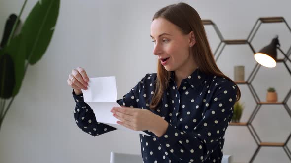 A Woman Receives a Notification Reads the Good News in a Letter alt