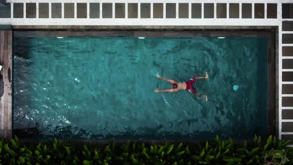 Young Man in Red Swimming Trunks Jump in the Pool alt