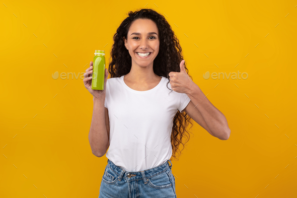 Portrait of Smiling Young Lady Drinking Smoothie Showing Like