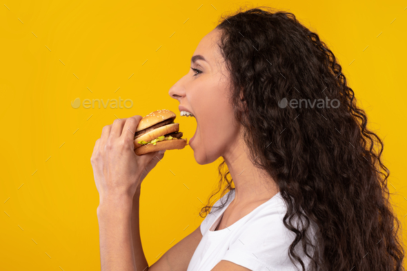 Funny Hungry Lady Holding Burger Biting Sandwich At Studio