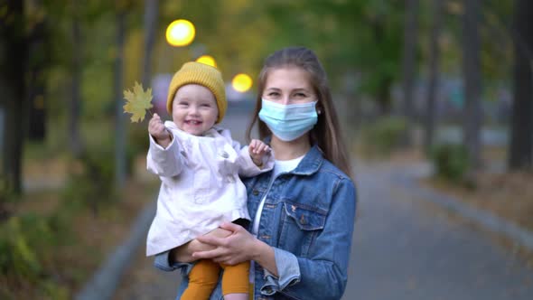 Masked Mother Holds Hand Lovely Daughter on Street Walk During Second Wave Quarantine Coronavirus alt